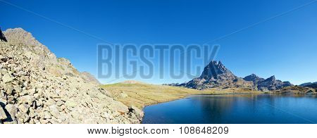 Midi Dossau Peak reflected in Ayous lake. Ossau Valley, Pyrenees National Park, Pyrenees, France.