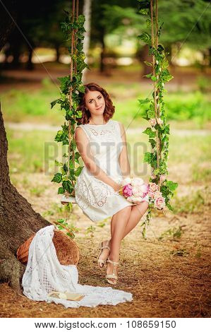 Beautiful young brunet woman in spring garden