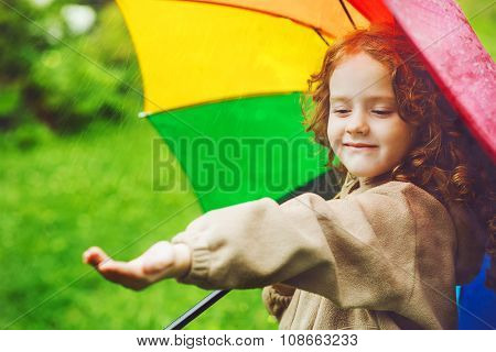 Little Girl  Hiding Under An Umbrella From The Rain