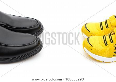 Yellow Shoes For Son And Black Ones For Dad On White As Filiation Concept