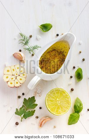 Ingrediets For Salad Dressing. Olive Oil, Garlic, Lemon, Herbs And Spices