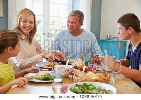 Family Enjoying Meal At Home Together