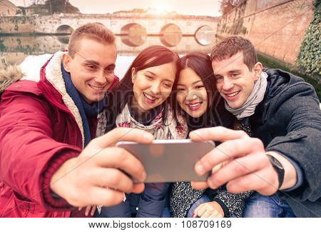Group Of Smiling Friends Taking Selfie Outdoor With Beautiful View -