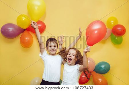Happy children with balloons at happy birthday party.