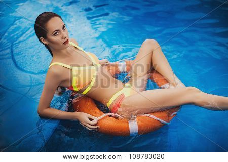 beautiful long hair female model posing by the pool