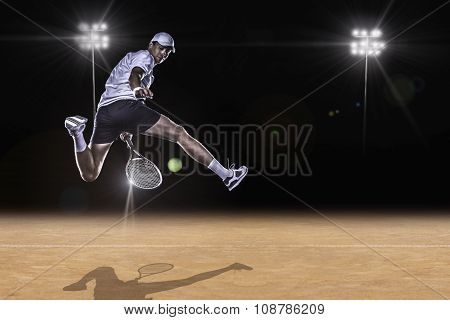 Tennis player reaching for the hard ball