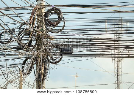 Lot Of Wire Cables Messy On Electricity Pole In The City For Safety Concept,  Background