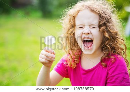 Girl Holds A Dandelion And Sneezes.