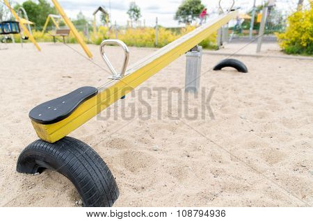 childhood, equipment and object concept - close up of swing or teeterboard on playground outdoors
