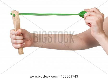 Hands Pulling Green Band Of Wooden Slingshot
