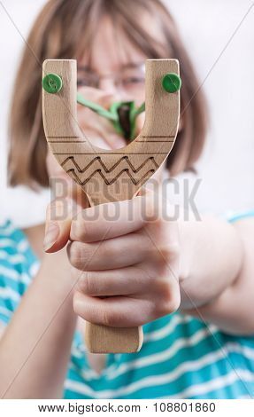 Direct View Of Girl Pulling Band Of Slingshot