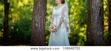 Beautiful bride in white dress in the garden