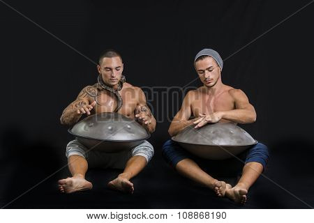 Male Drummers Drumming on Steel Drums in Studio
