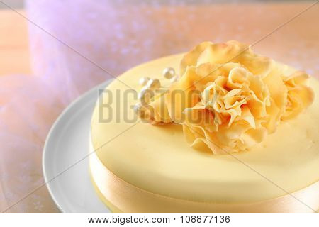 Cake with sugar paste flowers, on light background