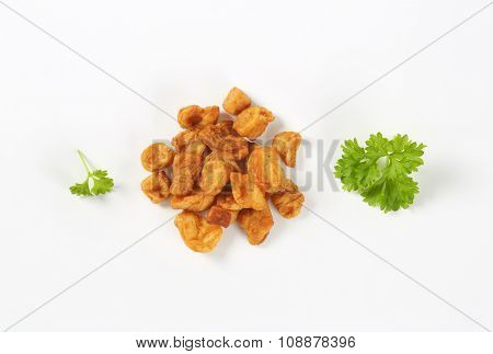 heap of pork greaves on white background