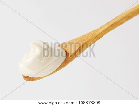 Creme fraiche on a wooden spoon