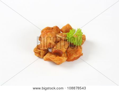 pile of pork greaves on white background
