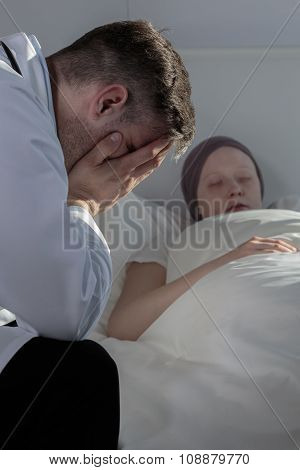 Hopeless Doctor Sitting Beside Patient