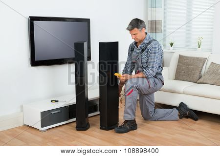 Technician Checking Tv Speaker With Multimeter