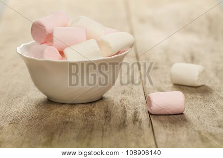 Sweet Marshmallows On White Plate On Wooden Background