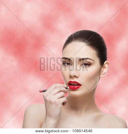Beautiful girl with lip pencil