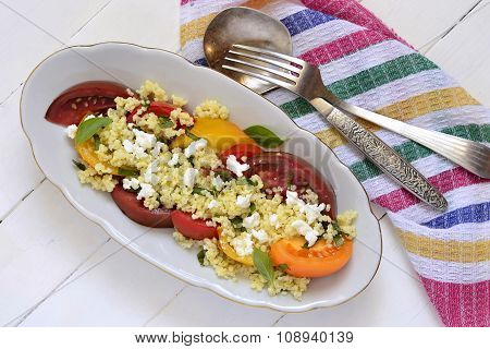 Millet with basil and fresh tomatoes and goat cheese