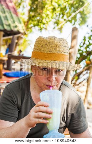 Woman Has A Fruit Drink In The Tropical   Restaurant