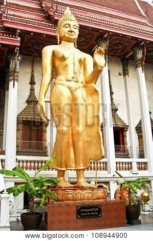 Standing Buddah In A Temple In Bangkok Is Giving A Handsign