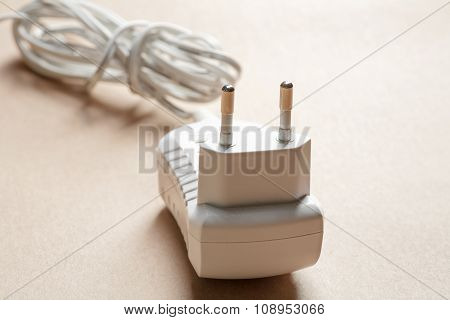 Ac Plug Digital Tablet Adapter On Brown Paper Background