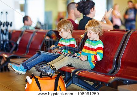 Two tired little sibling boys at the airport