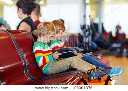 Two tired little sibling boys at the airport