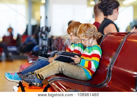 Two tired little sibling boys at the airport