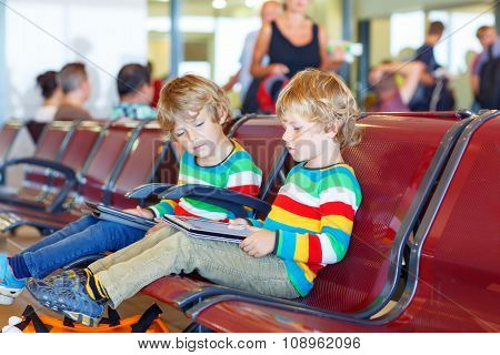 Two tired little sibling boys at the airport