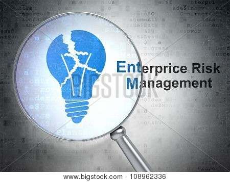 Finance concept: Light Bulb and Enterprice Risk Management with optical glass
