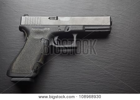 hand pistol gun on dark black background