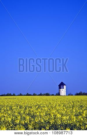 Water Tower In Beautiful Landscape With Blue Sky