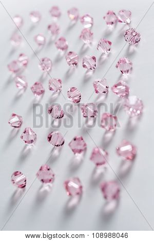 Collection Of Many Pink Double Cones Crystals In A White Box