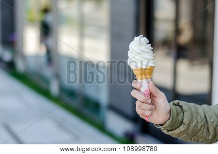 Hand Holds Conemilk Ice Cream At Otaru City.