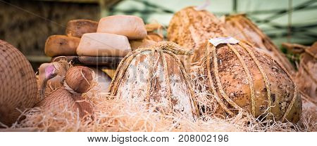 Cheeses and cut pieces in bulk on the counter of a market. Italian cheese.