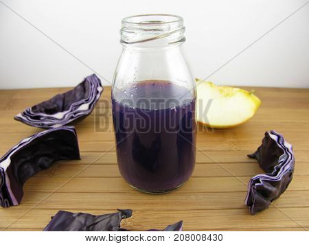 Red cabbage smoothie with apple in a bottle