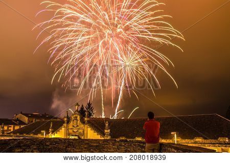 Guy watching fireworks in the local festival of San Froilan in Lugo. Spain.