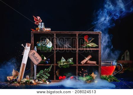 Shining Test Tube With Pixie Dust. Steaming Cup Of Tea In A Magical Still Life With Potion Ingredien
