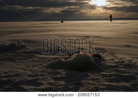 Fisherman On The River Covered With Ice