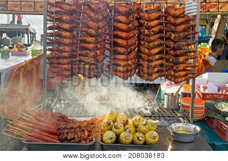 Grilled chicken wings chicken tails and corn at street market Kota kinabalu city Sabah Borneo Malaysia.