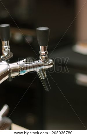 Beer faucet on bar ready to fuel a beer