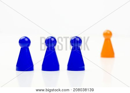 Close-up photo of a group of different-colored pieces in different positions on a white background - applicable to the team view