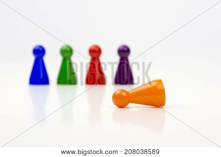 Close-up photo of a group of different-colored pieces in different positions on a white background - applicable to the team view