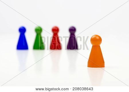 Close-up photo of a group of different-colored pieces in different positions on a white background - applicable to the team view
