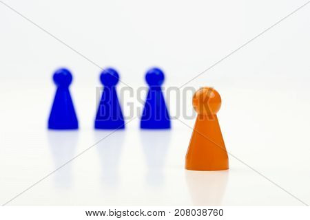Close-up photo of a group of different-colored pieces in different positions on a white background - applicable to the team view