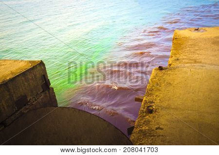The riverscape of large drainage steel pipe background. concept of industrial wastes and environmental pollution